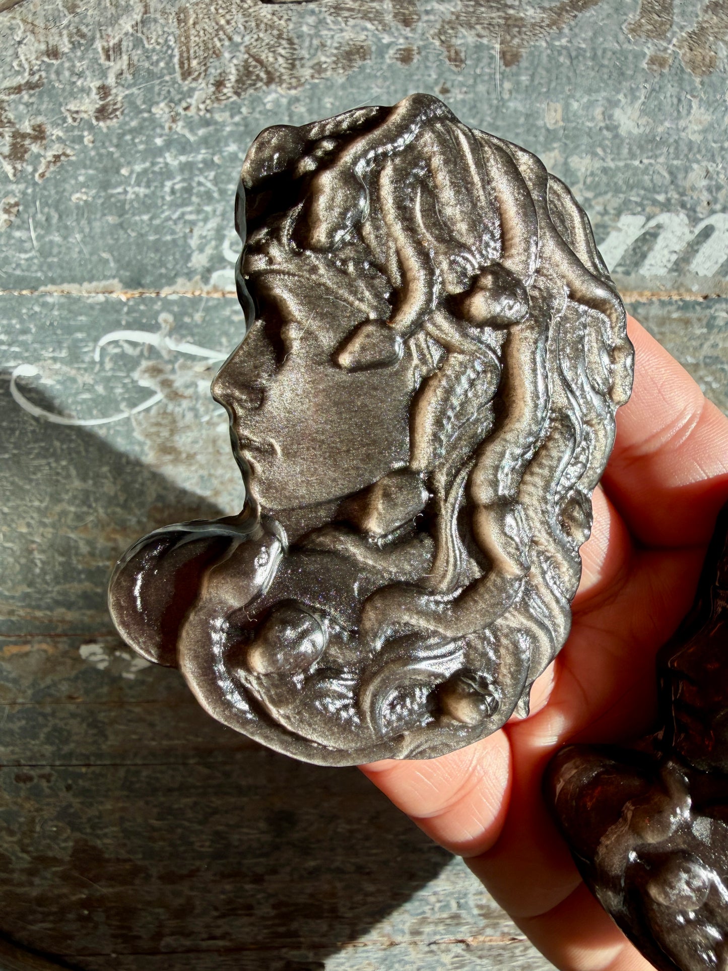 One (1) Silver Sheen Obsidian Medusa