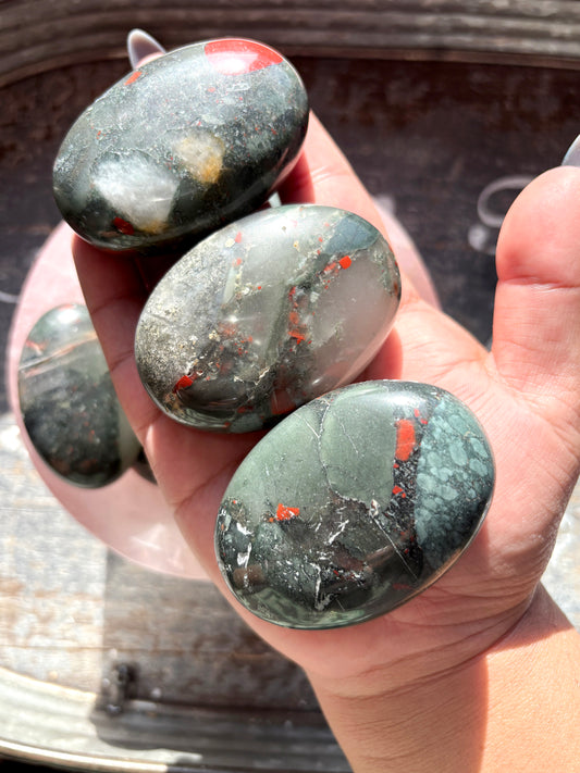 One (1) African Bloodstone Palmstone, intuitively chosen