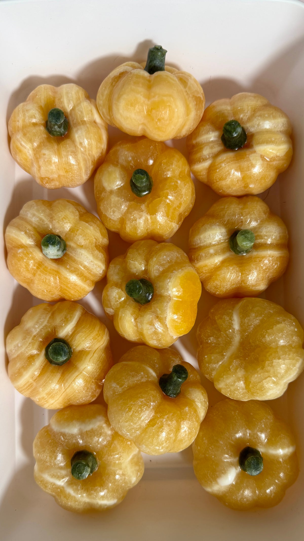 One (1) Orange Calcite Pumpkin (Serpentine Stem)